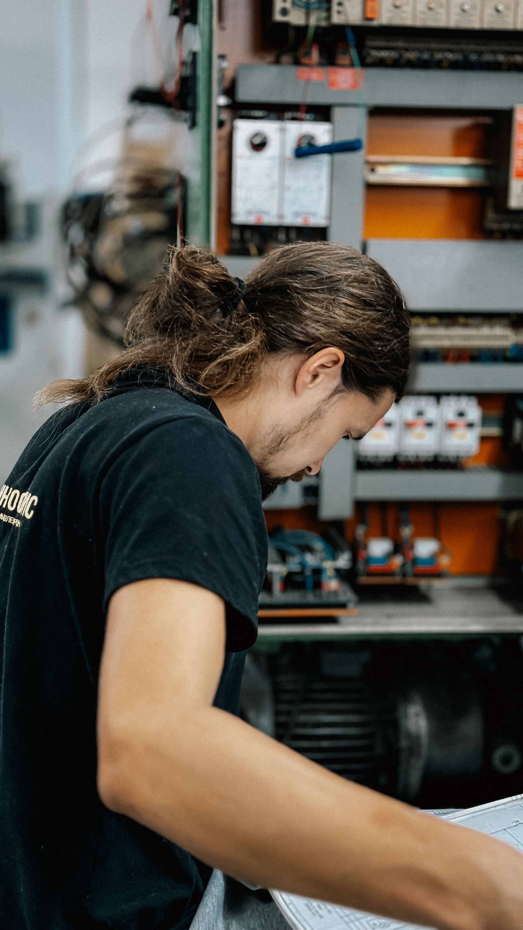 Electrician testing a circuit with a multimeter during diagnostics